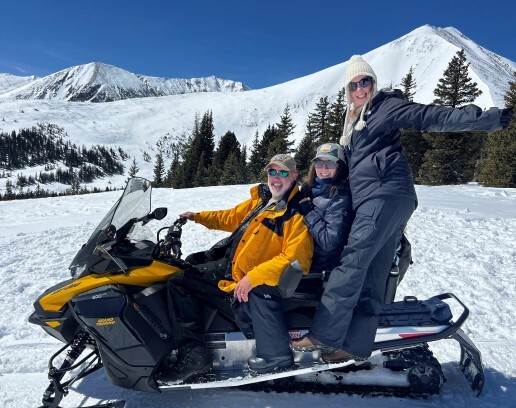 Melanie and friends on a Snowmobile